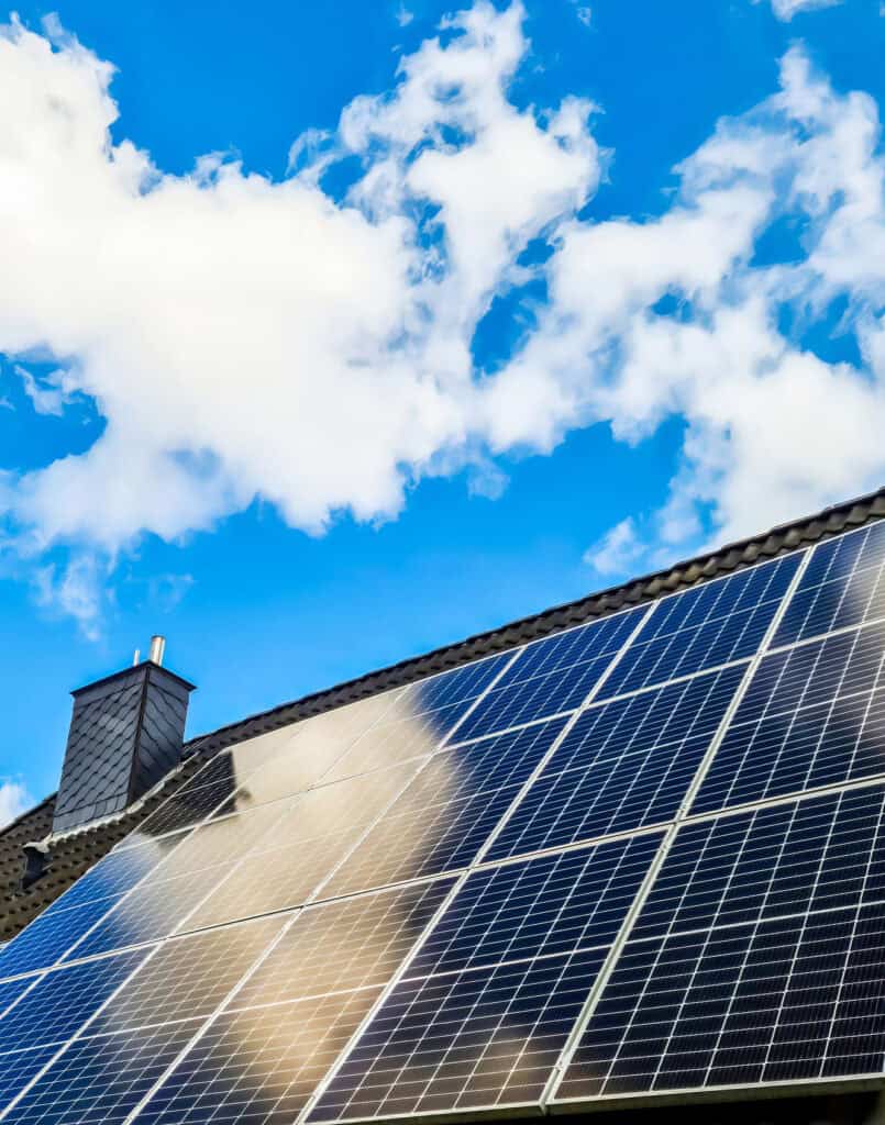 Rooftop solar panels under a blue sky