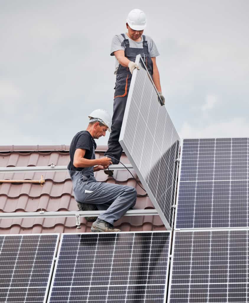 Technician repairing a rooftop solar array