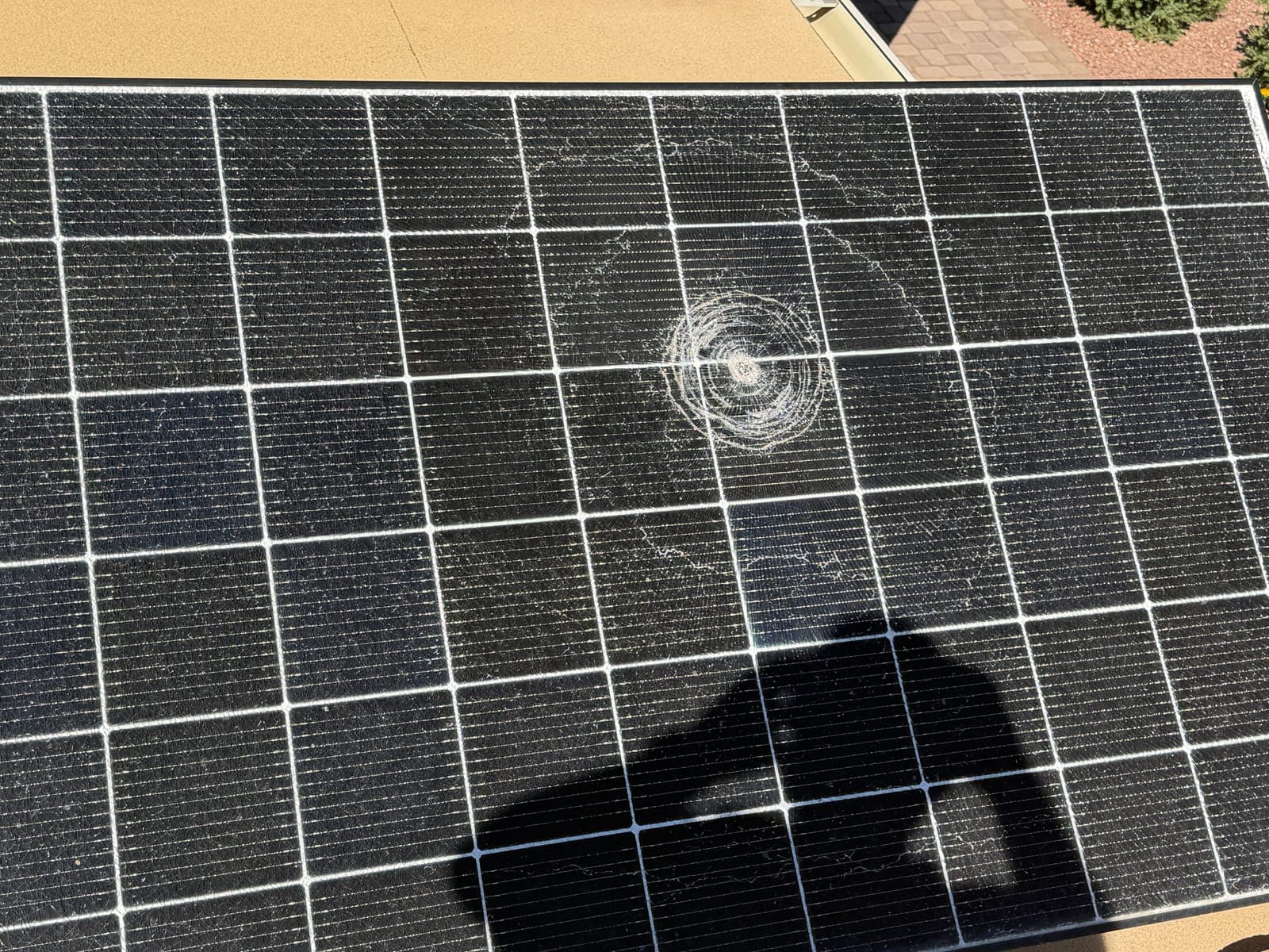 Solar panel glass shattered by an impact