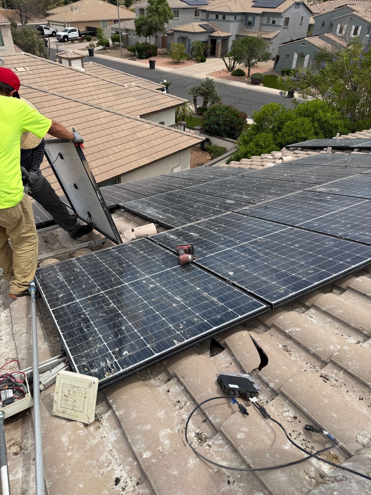 Crew lifting solar panels to reach pigeon nests