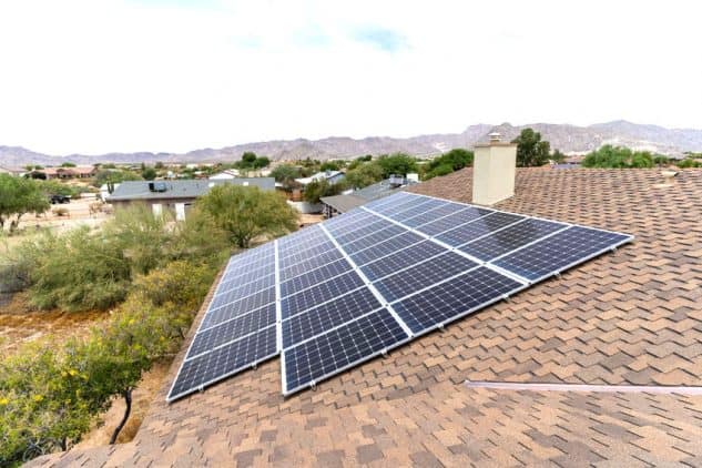 Rooftop solar array on a shingle roof in an Arizona desert neighborhood