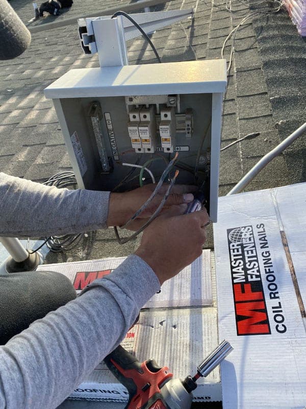 Technician disconnecting a solar system on the roof